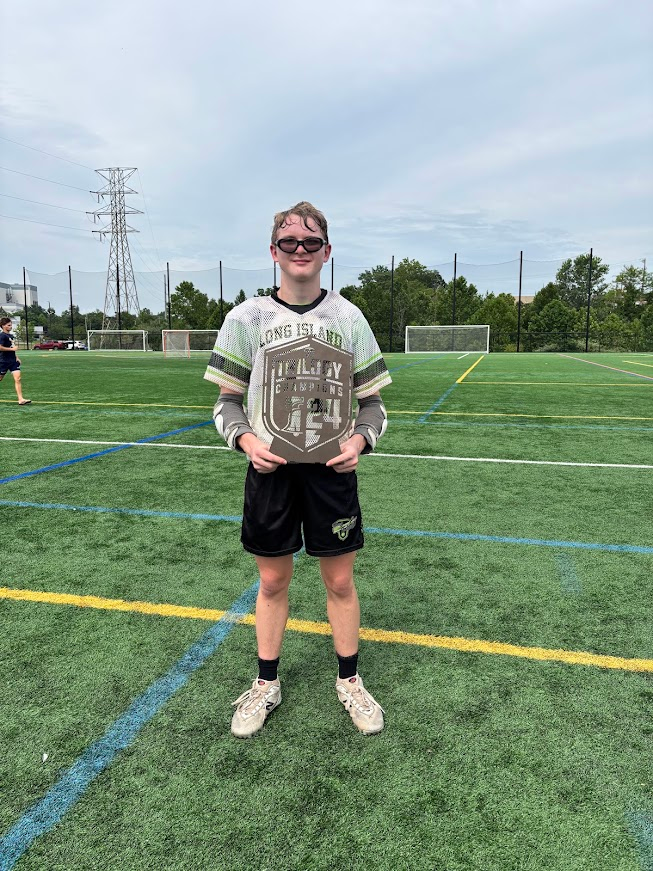 Holding a Long Island Champions plaque on the field